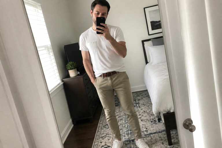22 Stylish Khaki Pants Outfit Ideas for Men Who Want an Easy Everyday Look Man in white t-shirt and khaki pants taking mirror selfie in bedroom