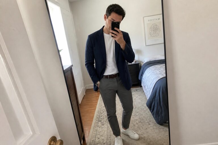 21 Clever Men’s Capsule Wardrobe Ideas for More Smart Casual Outfit Combinations Man in navy blazer and gray pants taking mirror selfie in bedroom